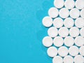 Group of white round pills on a blue background with copy space. Royalty Free Stock Photo