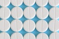 Group of white round pills on a blue background Royalty Free Stock Photo