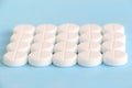 Group of white round pills on a blue background Royalty Free Stock Photo