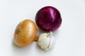 Group of whole ripe yellow onion, red onion and garlic on a white background Royalty Free Stock Photo