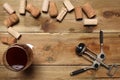 Group of wine bottle cork, a glass of red wine and a corkscrew on a wooden table with copy space for your text Royalty Free Stock Photo