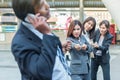 Group of woman pulling a rope competing with a businessman