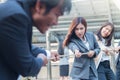 Group of woman pulling a rope competing with a businessman