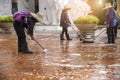 Group of  Woman worker cleaning the floor with scrubber brush  and polishing machine Royalty Free Stock Photo