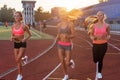 Group of women athletes running together in stadium. Royalty Free Stock Photo