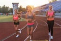 Group of women athletes running together in stadium. Royalty Free Stock Photo