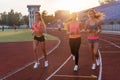 Group of women athletes running together in stadium. Royalty Free Stock Photo