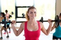 Group of women with barbells in gym