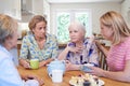 Group Of Women Consoling Unhappy Friend At Home