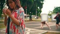 a group of women dancing contemporarily behind a sad woman in a park