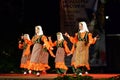 Turkish women dancing with wooden spoons at folklore festival stage