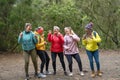 Group of women with different ages and ethnicities having a funny moment dancing during a walk foggy forest