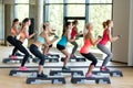 Group of women with dumbbells and steppers