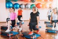 Group of women are engaged in step aerobics with dumbbells in their hands Royalty Free Stock Photo