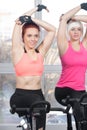 Group of women exercising on cycles Royalty Free Stock Photo