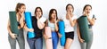 Group of women holding yoga mat standing over isolated background hand on mouth telling secret rumor, whispering malicious talk Royalty Free Stock Photo