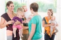 Group of women learning how to use baby slings for mother-child Royalty Free Stock Photo