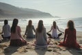 A group of women meditating on a beach sit on the sand