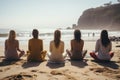 A group of women meditating on a beach sit on the sand