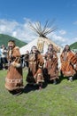 Group of women in national clothing aborigine of Kamchatka expression dancing near yaranga