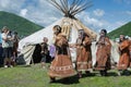 Group of women in national clothing aborigine of Kamchatka expression dancing near yaranga