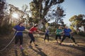 Group of women playing tug of war during obstacle course training Royalty Free Stock Photo