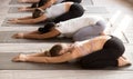 Group of women practicing yoga lesson in Balasana pose Royalty Free Stock Photo