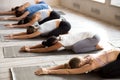 Group of women practicing yoga lesson doing Balasana exercise