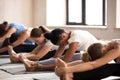 Group of women practicing yoga in paschimottanasana pose Royalty Free Stock Photo