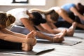 Group of women practicing yoga, Seated forward bend exercise Royalty Free Stock Photo
