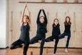 Group of women practicing yoga stretching using wooden blocks, exercise for spine and shoulders flexibility Royalty Free Stock Photo