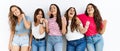 Group of women wearing casual clothes standing over isolated background very happy and excited doing winner gesture with arms Royalty Free Stock Photo