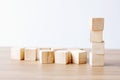 Group wooden cubes on table over white cement background, mock u