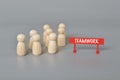 A group of wooden figure with text TEAMWORK. Unity and teamwork in corporate workplace concept Royalty Free Stock Photo