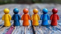 A group of wooden figurines are lined up in a row, AI Royalty Free Stock Photo