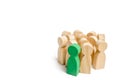 Group of wooden people figurines. Green man stands out from group, Crowd, meeting, social activity. Society, social group. Herd in Royalty Free Stock Photo