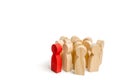 Group of wooden people figurines. Red man stands out from group, Crowd, meeting, social activity. Society, social group. Herd inst Royalty Free Stock Photo