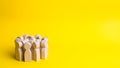 Group of wooden people figurines on a yellow background. Crowd, Royalty Free Stock Photo