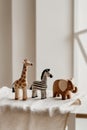 Group of wooden toy animals standing on a light brown fabric. Royalty Free Stock Photo