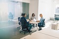 Group of work colleagues laughing during an office meeting toget