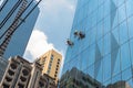 A group of worker cleaning the glass curtain wall of a modern glassy office skyscraper. At the Ortigas CBD, Metro Manila Royalty Free Stock Photo