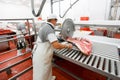 A group of worker in meat factory, chopped a fresh beef meat in pieces on work, industry food Royalty Free Stock Photo