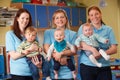 Group Of Workers With Babies In Nursery Royalty Free Stock Photo