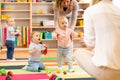 Group of workers with babies in nursery Royalty Free Stock Photo