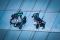 Group of workers cleaning windows service on high rise building Royalty Free Stock Photo