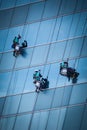 Group of workers cleaning windows service on high rise building