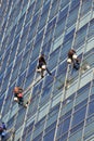 group of workers cleaning windows service on high rise building Royalty Free Stock Photo