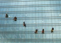 Group of workers cleaning windows service on high rise building. window washers industrial climbers Royalty Free Stock Photo