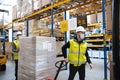 Group of workers with face mask working indoors in warehouse, coronavirus concept.