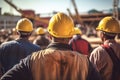Group of workers in hardhats at construction site. Selective focus, rear view of Construction workers at the construction site
